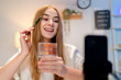 © Kawee - Caucasian young beauty blogger recording video content about cosmetics.