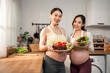 © Kawee - Portrait of Two pregnant women enjoy healthy lifestyle for prenatal wellness.