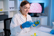 © Kawee - Caucasian female scientist in white lab coat working in the laboratory.