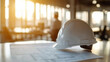 © khemthong - Business partnership agreement in a modern office with construction plans and hard hat