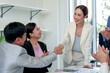 © Crystal - Business partners shaking hands in a corporate office meeting, colleagues clapping, showing successful partnership and agreement