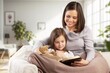 © BillionPhotos.com - Family with small daughter reading book in living room
