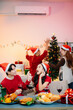 © laddawan - Enjoy the holiday spirit with a joyful Christmas celebration featuring friends, festive food, Santa hats,