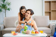 © laddawan - Fit couple preparing healthy food at home, featuring fresh fruits, salad, and wellness