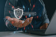 © MUNTHITA - Cybersecurity concept with a holographic lock and shield above a laptop, representing password protection, data privacy, encryption and secure online network technology for internet safety.