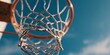 © haidar - Basketball hoop with a clear blue sky background, close-up