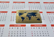 © Nadzeya - Gold credit card resting on a calendar showing months and dates throughout the year concept