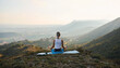 © Marc Elias - Woman meditating on mountain top at sunrise in peaceful nature