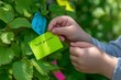 © Jane_S - Child attaching thank you note to tree in nature conservation activity