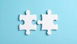 © Rosdiana - two white puzzle pieces matching together againt light blue background