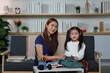 © itchaznong - Mother and Daughter Preparing for School. A joyful moment in a cozy home.