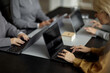 © Seventyfour - Group of Middle Aged Women Collaborating on Laptops in Office