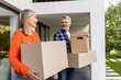 © zinkevych - Senior man and woman working together carrying home boxes during relocating