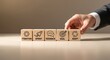 © QuiinL - Businessman's hand arranging wooden blocks with icons representing agile project management principles like iteration, sprint, and feedback.