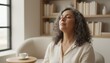 © Anna - A mature latina woman with gray hair relaxing at home with her eyes closed. Middle-aged person practicing mindfulness and deep breathing for stress relief. Mental wellness and self-care concept