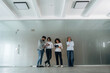 © standret - Front view of four office workers that are standing indoors and waiting