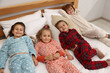 © New Africa - Cute children in pajamas on bed at home