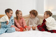 © New Africa - Cute children in pajamas on bed at home