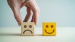 © Brishy  - Hand changes sad to happy face block, reflecting improved customer satisfaction and positive service feedback