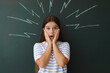 © New Africa - Back to school. Emotional girl near chalkboard with drawn lightning bolts indoors