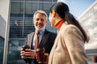 © Marko Geber - Mature business professionals having coffee outdoors
