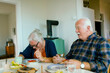 © Davor - Senior couple enjoying breakfast at home