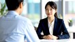 © FREEDOM - 若い日本人女性がオフィスで面接をしているイメージ 16:9サイズ