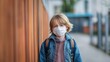 © Sawitree88 - A child wearing a face mask returns to school during the COVID-19 lockdown and quarantine.