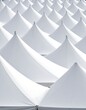 © pertalit - Aerial view of many white conical tents, creating a repeating pattern
