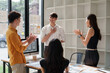 © crizzystudio - Young team congratulating colleague for success and achievement