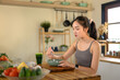 © Prathankarnpap - Photo set of woman enjoying a bowl of yogurt with fresh fruit at home, representing healthy eating, balanced nutrition