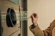 © Westend61 - Hand recycling plastic bottle in bottle deposit system collection machine
