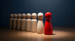 © MAHFUJ - One red wooden figure stands out from a line of identical figures symbolizing leadership and individuality