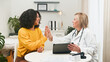 © Meeko Media - Doctor High-Fives Patient In Clinic After Friendly Consultation And Checkup