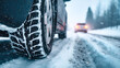 © sornram - Close-up of a winter tire navigating through a snowy road, showcasing traction for safe driving in harsh conditions.