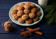 © Md Islam - Plate of ginger nut cookies with cinnamon sticks and pine