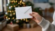 © forenna - White letter paper mockup held by a child’s hand near glowing Christmas tree decorations, emotion of hope and happiness visible, representing festive greeting design, holiday communication, and