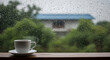 © Suresh - Cup of Hot Drinks on wooden table in rainy day