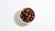 © vxnaghiyev - Brown chestnuts arranged in a bowl on a light background, fiber-dense choice