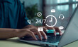 © paripat - Customer service support 24-7 concept with business person typing on laptop. Icons of communication, headset, email, and chat represent online assistance and digital helpdesk technology.