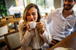 © Mediteraneo - Woman enjoying coffee with friends in cafe