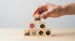 © MEMEsoBlue - A hand stacking wooden blocks with business growth, financial chart, clock, and brain icons, representing strategic planning and success