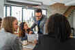 © Miljan Živković - Business professionals collaborating at a meeting in modern office
