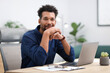 © New Africa - Portrait of man at table in office