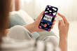 © New Africa - Woman playing online poker on mobile phone indoors, closeup