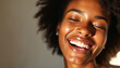 © Viktor - Smiling black woman with curly hair. Happy african american female model laughing. Closeup face of young woman with healthy skin, afro hairstyle. Woman with glowing skin, joyful expression on face.