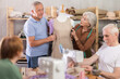 © JackF - Group of elderly men and women sew and work with mannequin during master class