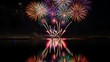 © Adobe - Colorful pyrotechnics explode over a calm lake at night, reflected in the water