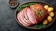 © DreamGrid - Delicious glazed ham with roasted potatoes and rosemary on a wooden platter