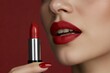 © GraphixStudio - Woman applying vibrant red lipstick, closeup of lips and cosmetic product